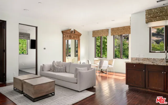a living room with furniture fireplace and window