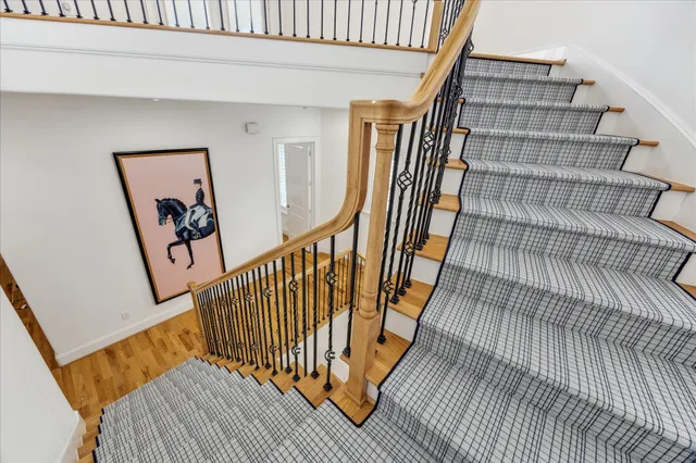 a view of staircase with white walls and a window