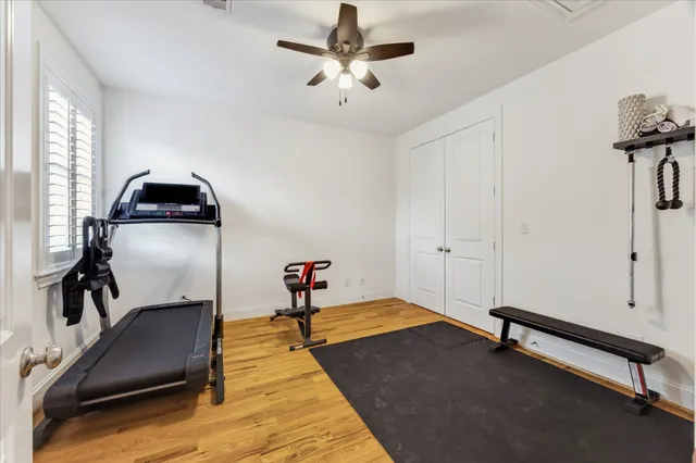 a room with gym equipment and a chandelier