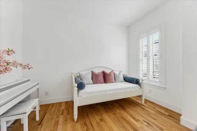 a bedroom with a bed and wooden floor