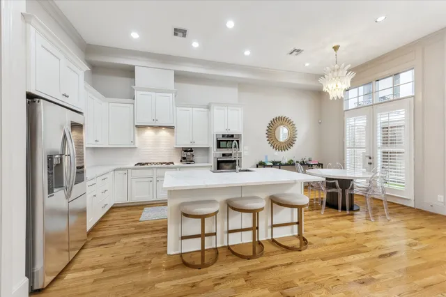 a large kitchen with a table and chairs in it