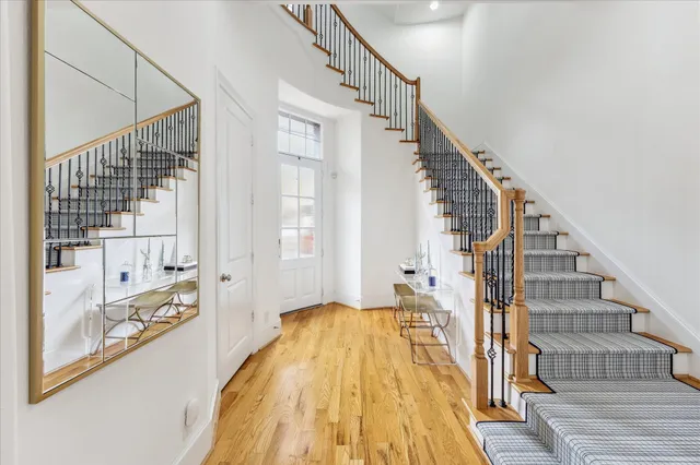 a view of staircase with large window and wooden floor