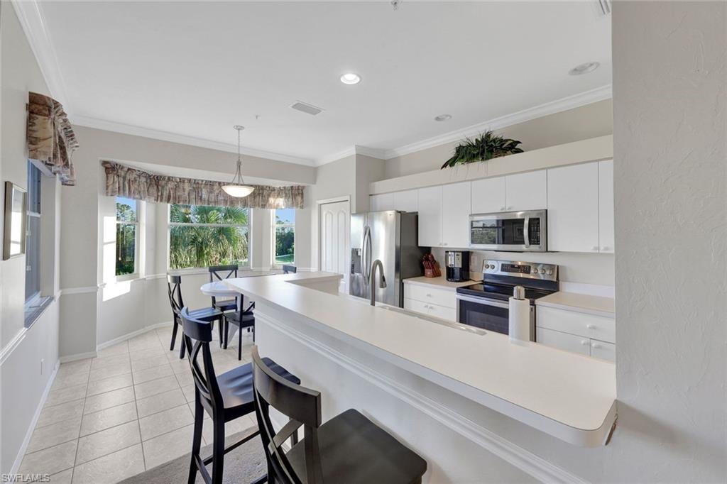 8680 Cedar Hammock Circle, Unit 142 Naples, FL 34112 - Photo 12 of 27 a view of a dining room with furniture window and outside view
