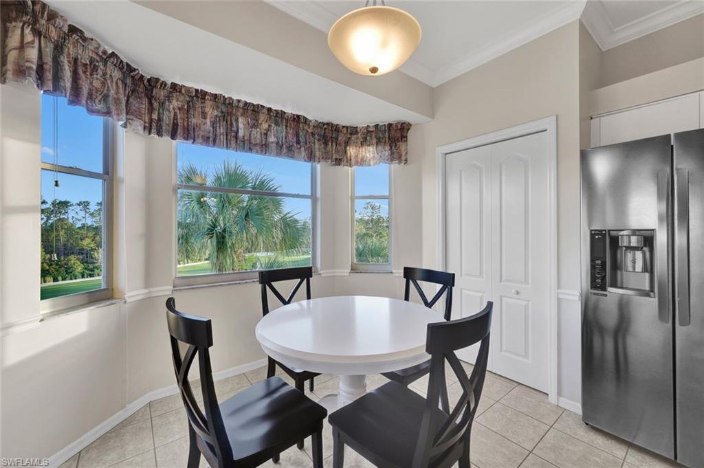 8680 Cedar Hammock Circle, Unit 142 Naples, FL 34112 - Photo 14 of 27 a view of a dining room with furniture window and outside view