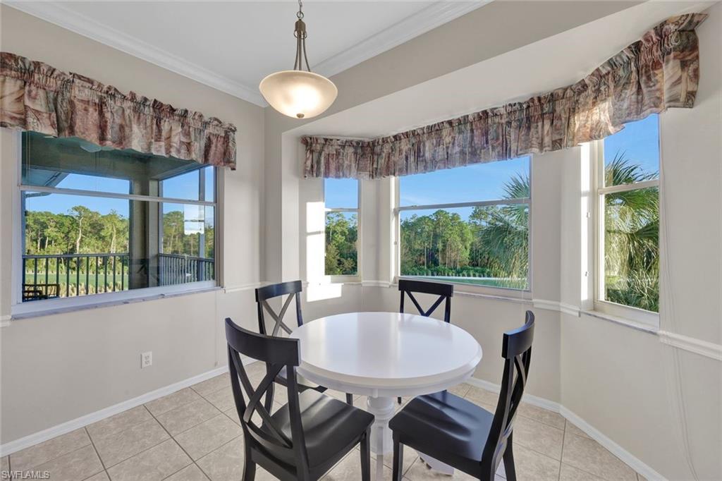 8680 Cedar Hammock Circle, Unit 142 Naples, FL 34112 - Photo 15 of 27 a view of a dining room with furniture window and outside view