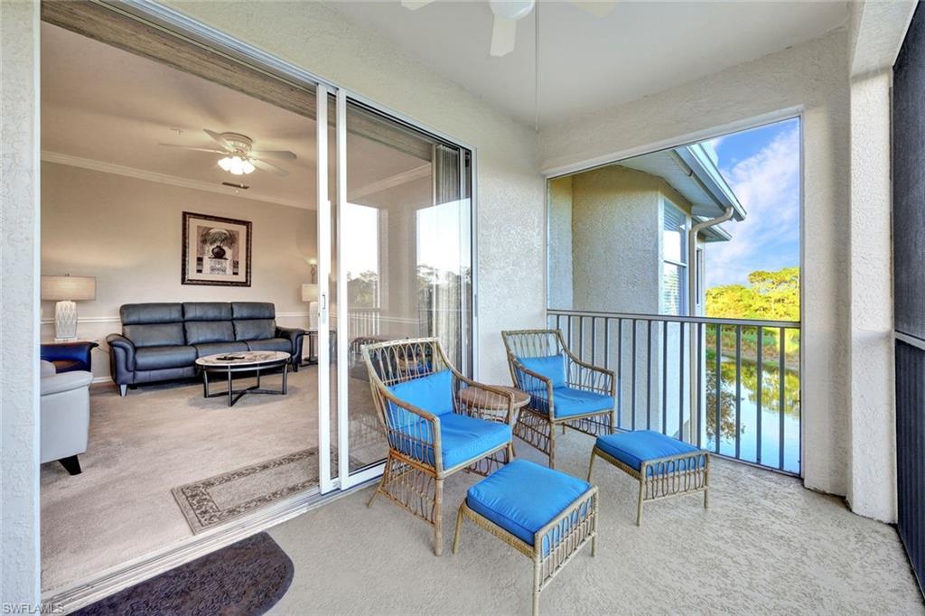 8680 Cedar Hammock Circle, Unit 142 Naples, FL 34112 - Photo 16 of 27 a living room with furniture and a table