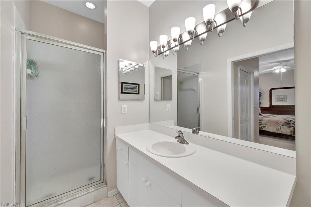 8680 Cedar Hammock Circle, Unit 142 Naples, FL 34112 - Photo 18 of 27 a bathroom with a sink shower and a mirror