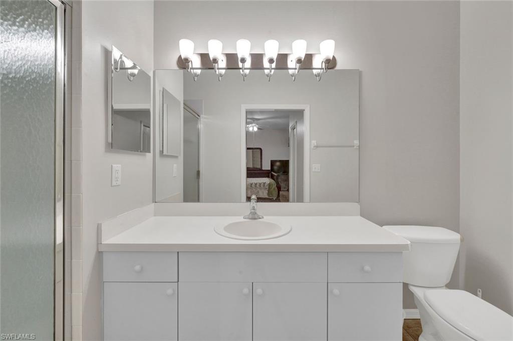 8680 Cedar Hammock Circle, Unit 142 Naples, FL 34112 - Photo 19 of 27 a bathroom with a sink and a mirror