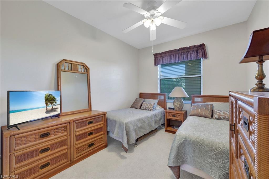 8680 Cedar Hammock Circle, Unit 142 Naples, FL 34112 - Photo 20 of 27 a living room with furniture and a dresser