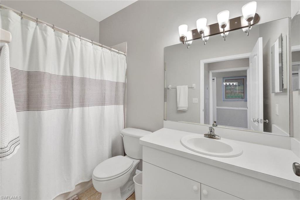 8680 Cedar Hammock Circle, Unit 142 Naples, FL 34112 - Photo 22 of 27 a bathroom with a sink and a mirror