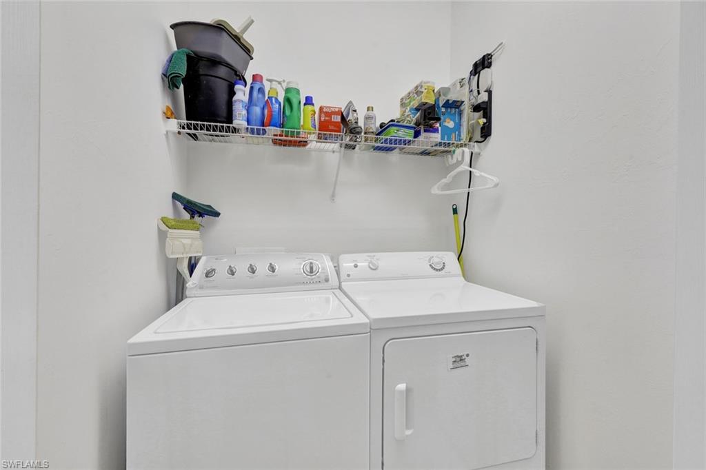 8680 Cedar Hammock Circle, Unit 142 Naples, FL 34112 - Photo 23 of 27 a utility room with dryer and washer