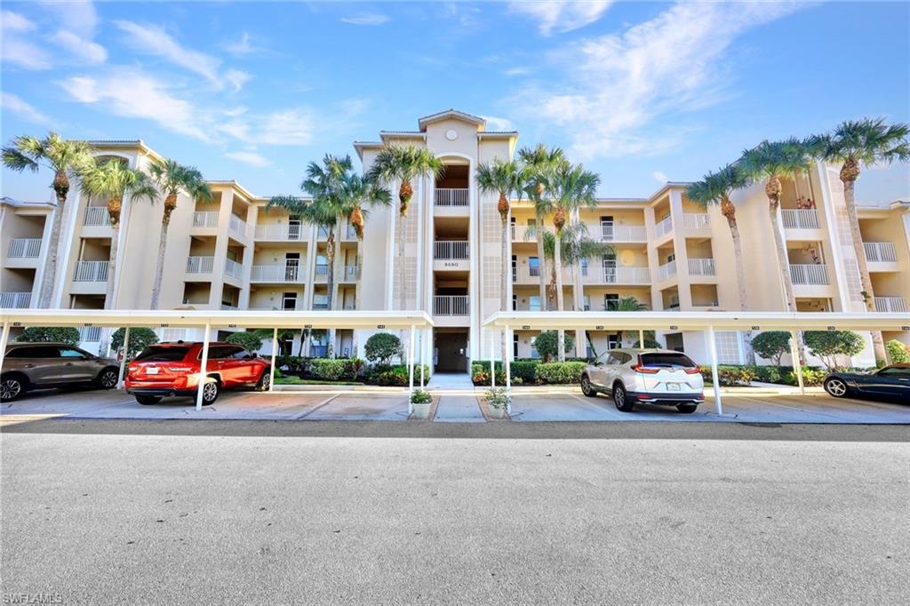 8680 Cedar Hammock Circle, Unit 142 Naples, FL 34112 - Photo 5 of 27 a cars parked in front of a building
