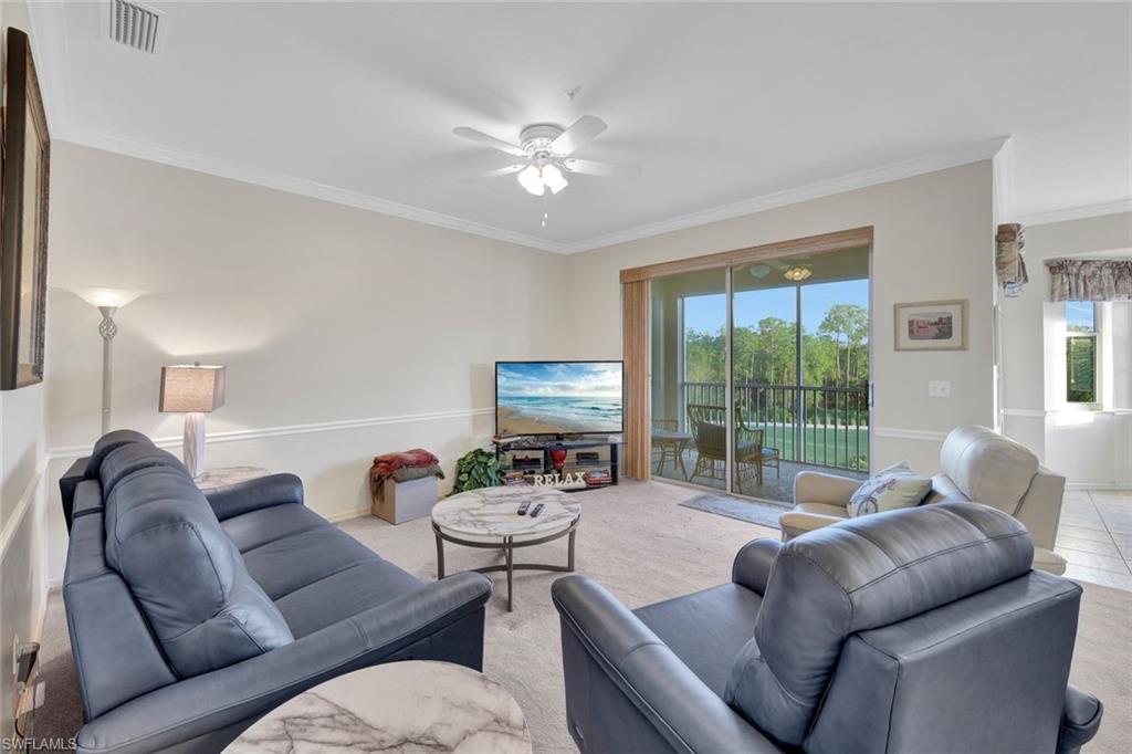 8680 Cedar Hammock Circle, Unit 142 Naples, FL 34112 - Photo 6 of 27 a living room with furniture and a large window