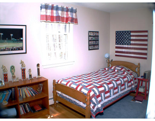 135 Raleigh Tavern Lane North Andover, MA 01845 - Photo 17 of 21 a bedroom with a bed and dresser with wooden floor