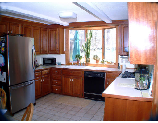135 Raleigh Tavern Lane North Andover, MA 01845 - Photo 4 of 21 a kitchen with a refrigerator and a sink