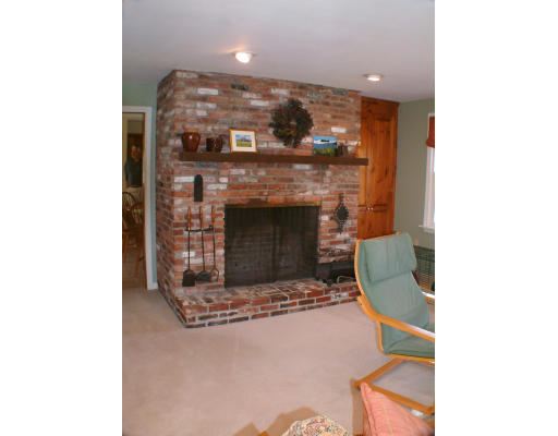 135 Raleigh Tavern Lane North Andover, MA 01845 - Photo 10 of 21 a living room with furniture and a fireplace