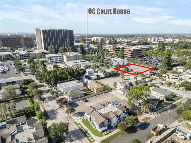 a view of a street with flower garden in front of it