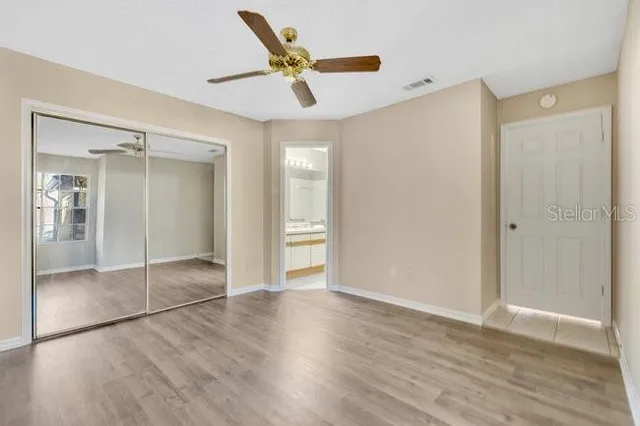 a bathroom with a sink a toilet a mirror and shower