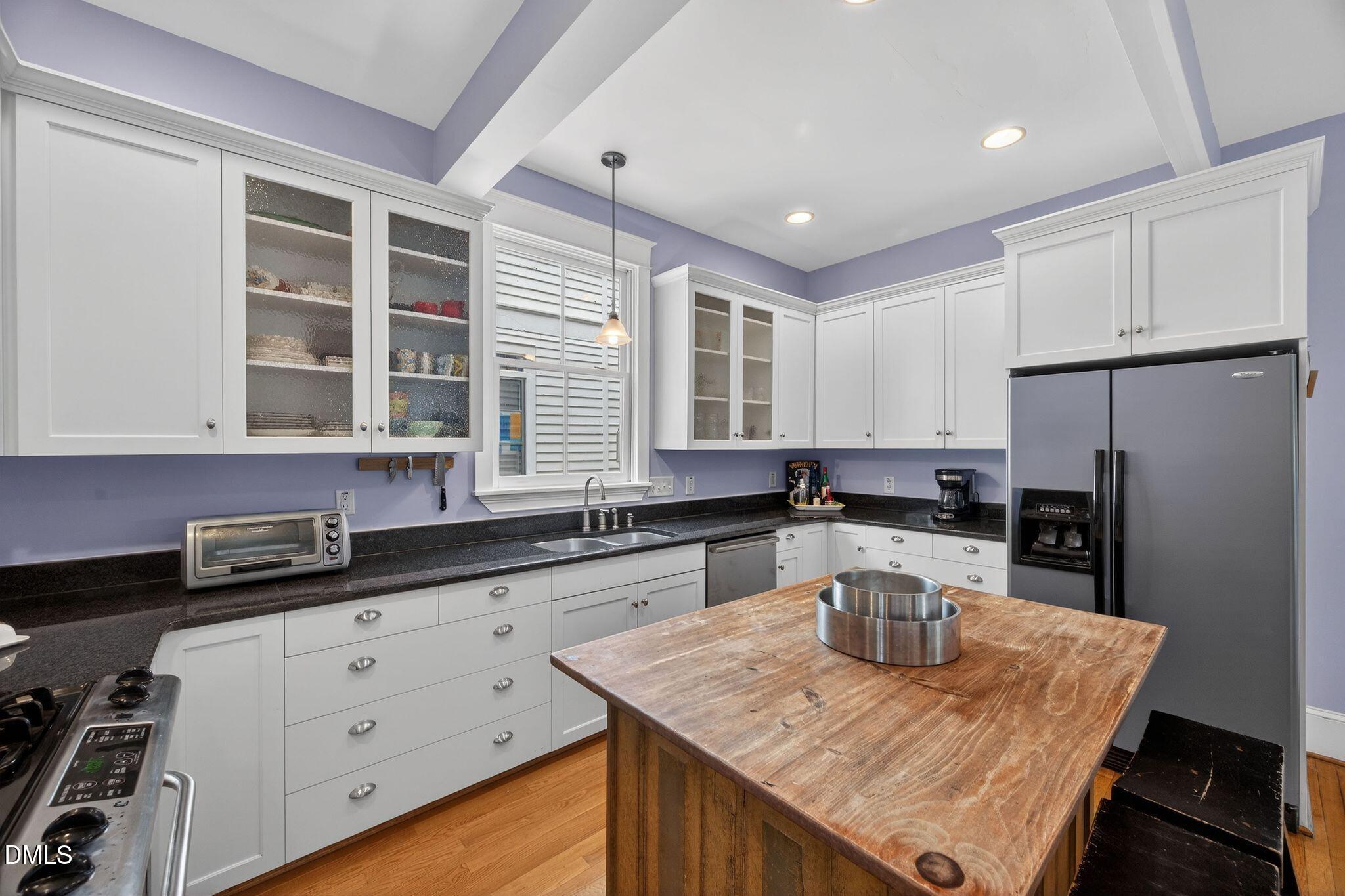 218 Pace Street Raleigh, NC 27604 - Photo 16 of 43 a kitchen with granite countertop a sink a counter space appliances and cabinets