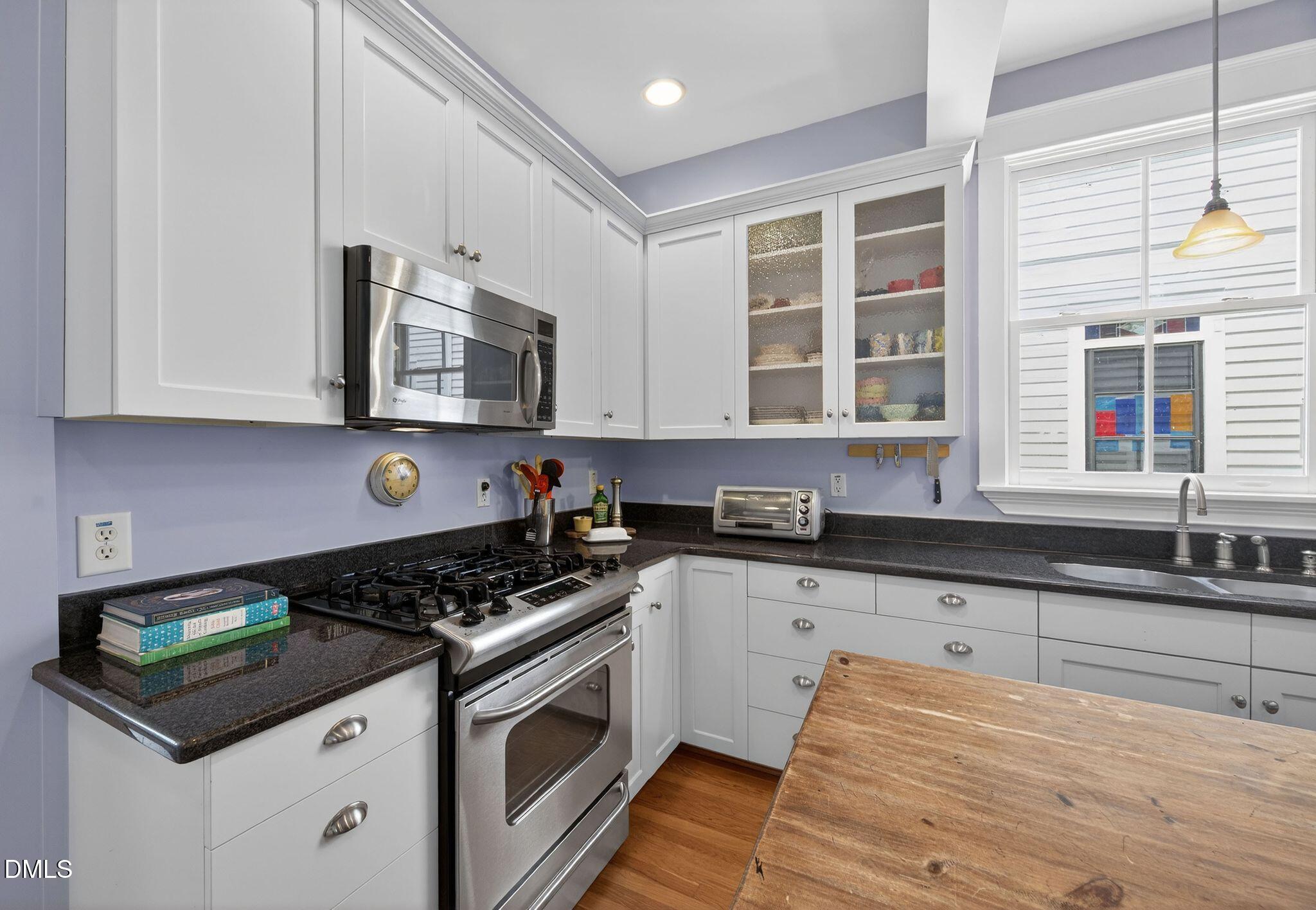 218 Pace Street Raleigh, NC 27604 - Photo 17 of 43 a kitchen with stainless steel appliances granite countertop a stove and a sink