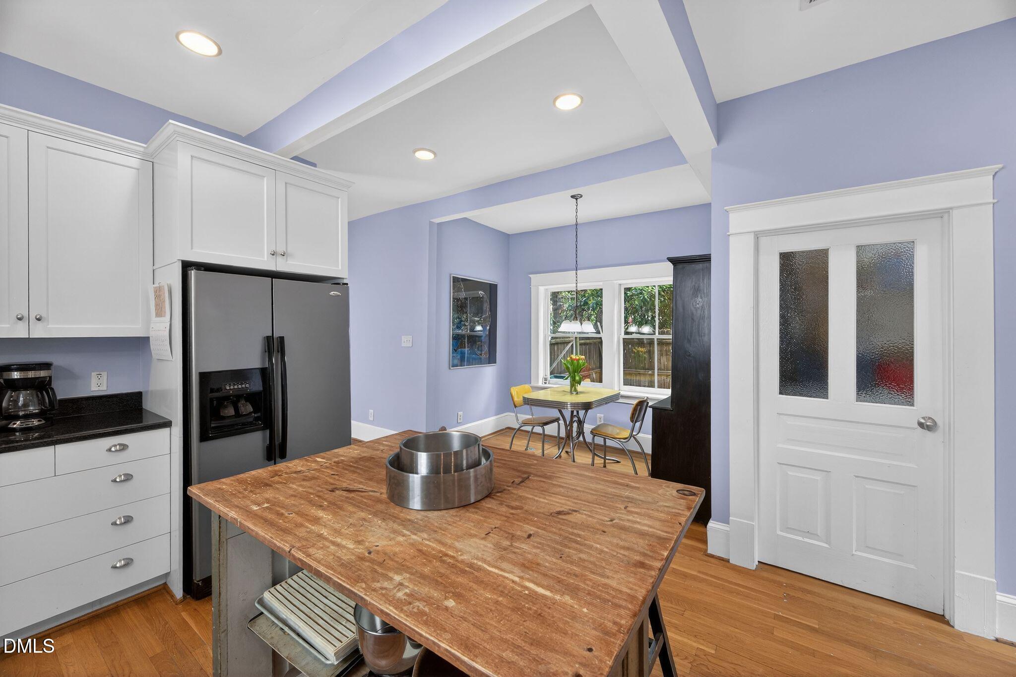 218 Pace Street Raleigh, NC 27604 - Photo 18 of 43 a kitchen with a table chairs refrigerator and cabinets