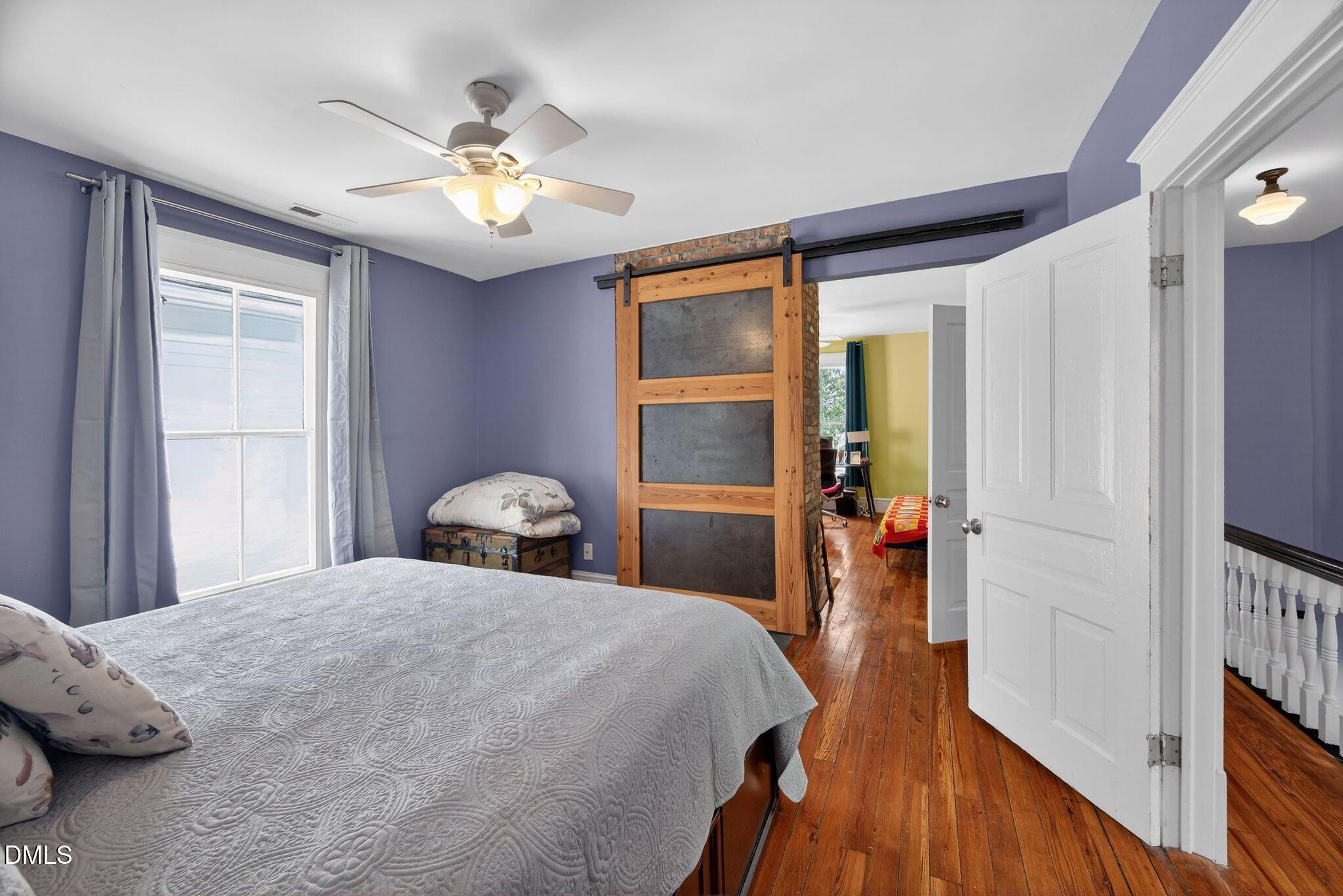 218 Pace Street Raleigh, NC 27604 - Photo 23 of 43 a bedroom with a bed and a chandelier