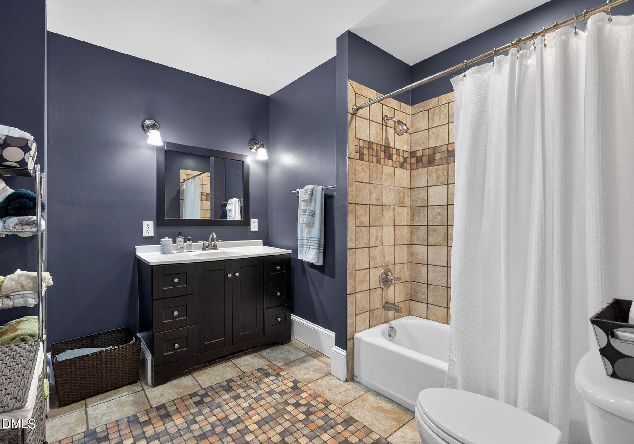 218 Pace Street Raleigh, NC 27604 - Photo 25 of 43 a bathroom with a bathtub sink vanity mirror and toilet