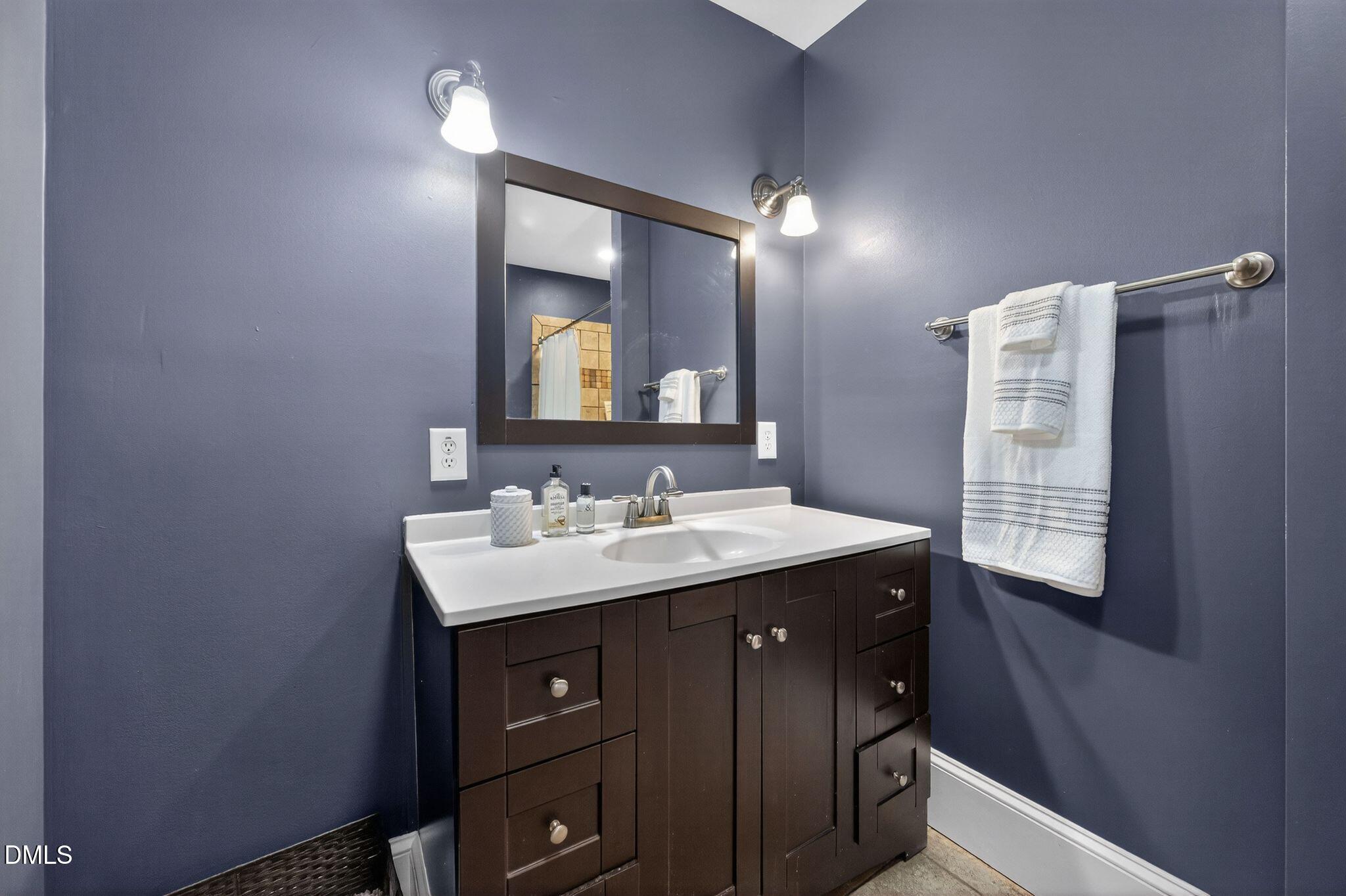 218 Pace Street Raleigh, NC 27604 - Photo 26 of 43 a bathroom with a sink a light fixture and a mirror