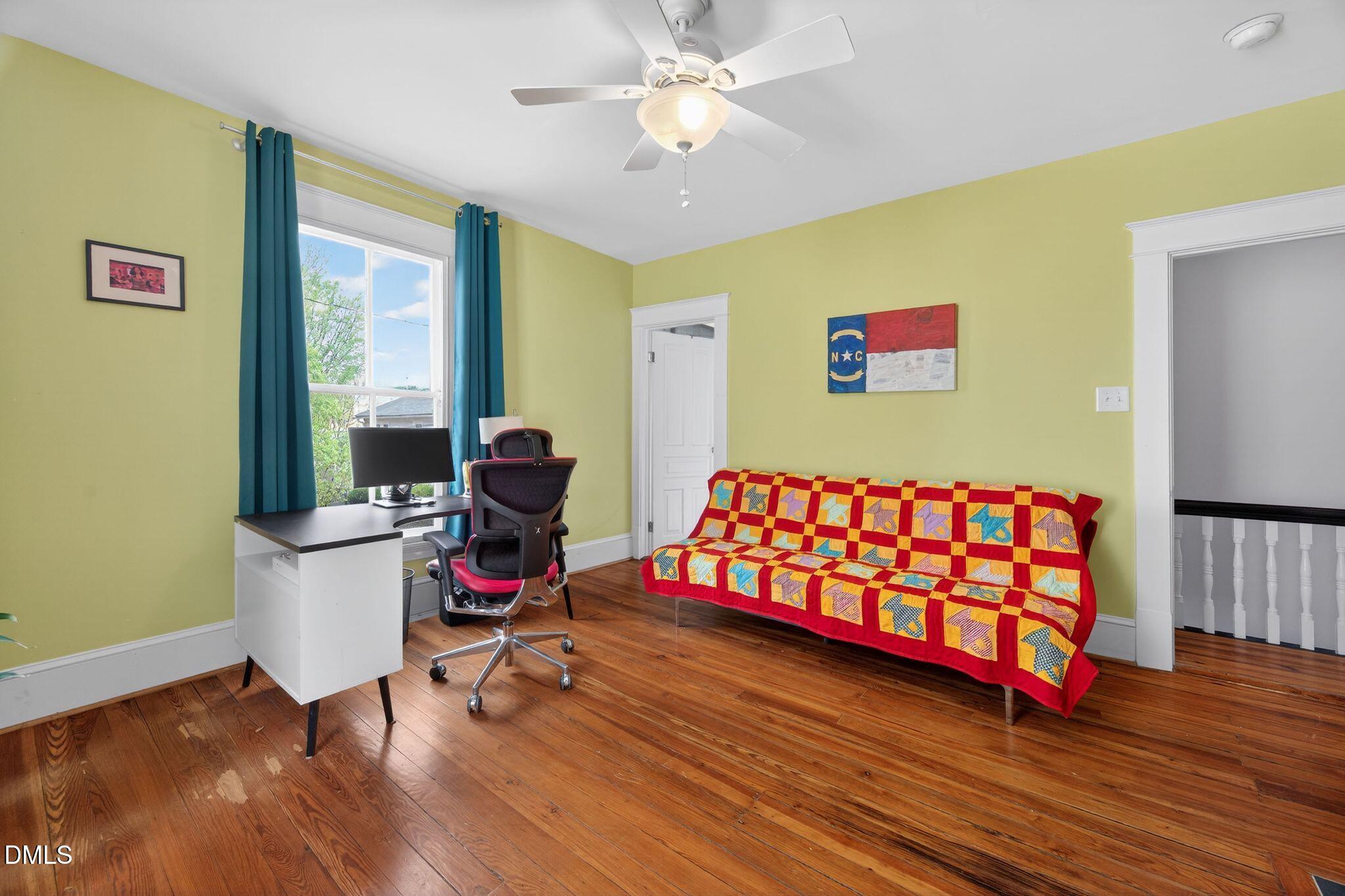 218 Pace Street Raleigh, NC 27604 - Photo 29 of 43 a bedroom with a bed and wooden floor