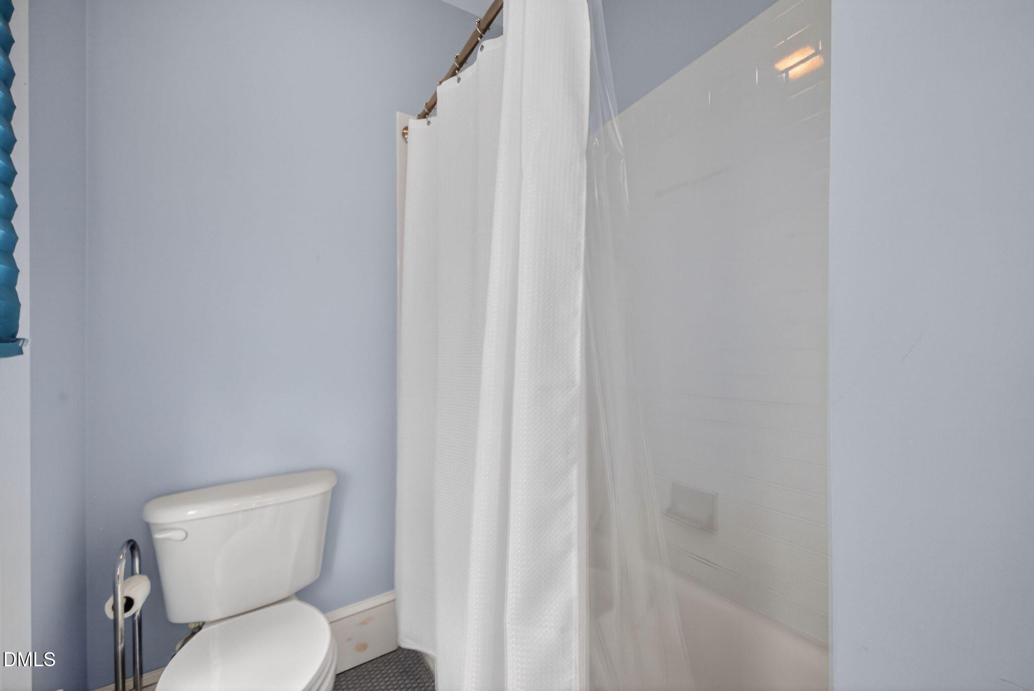 218 Pace Street Raleigh, NC 27604 - Photo 32 of 43 a white toilet sitting next to a shower