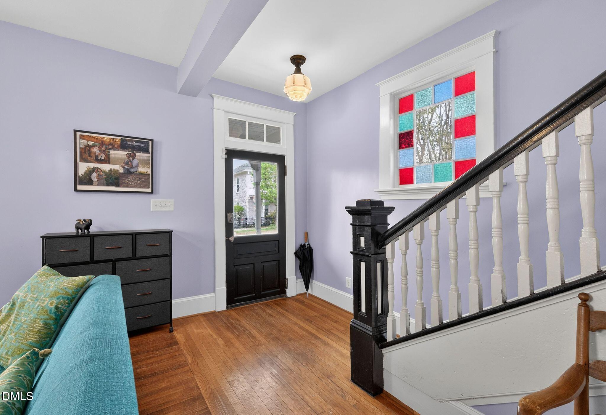 218 Pace Street Raleigh, NC 27604 - Photo 4 of 43 a view of a hallway to a livingroom with wooden floor and furniture