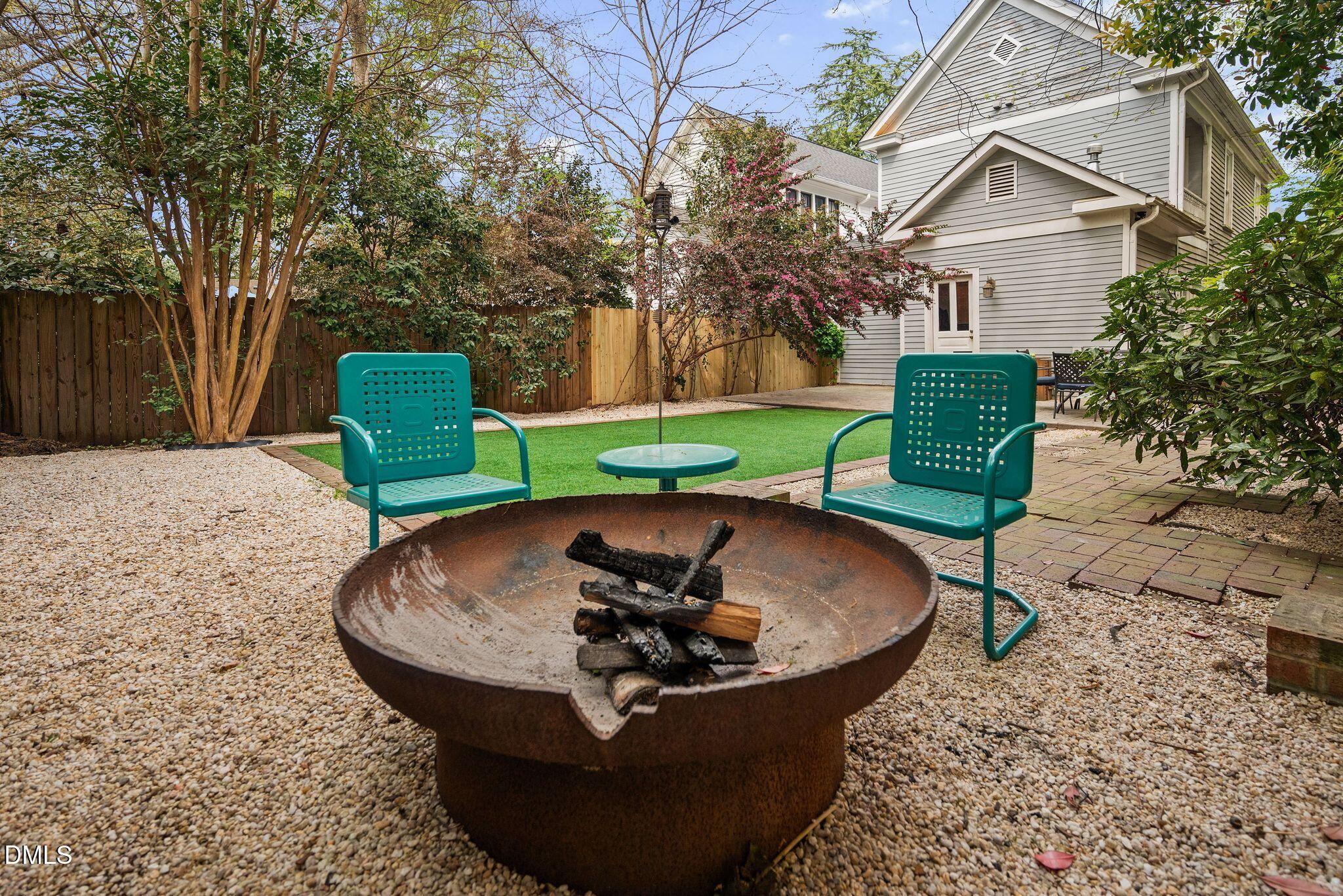 218 Pace Street Raleigh, NC 27604 - Photo 41 of 43 a view of a backyard with table and chairs potted plants and large tree