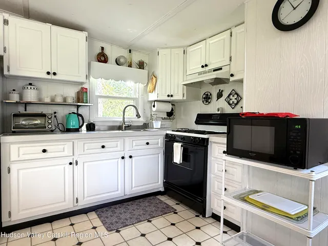 a kitchen with stainless steel appliances granite countertop a sink and a stove