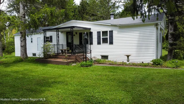 a front view of a house with a garden