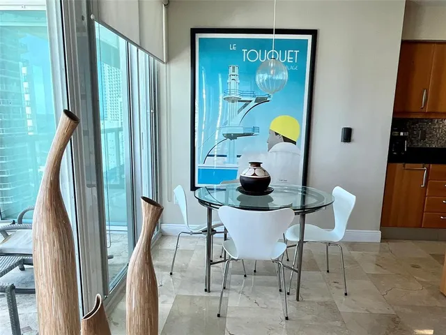 a view of a room with furniture and a window