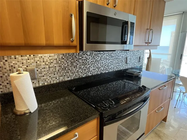 a kitchen with granite countertop stainless steel appliances and sink