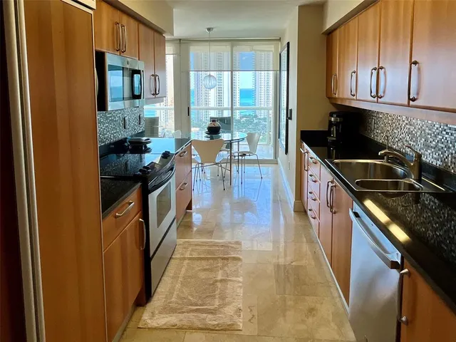 a bedroom with a large bed and a flat tv screen