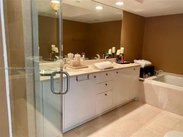 a bathroom with a shower sink and mirror