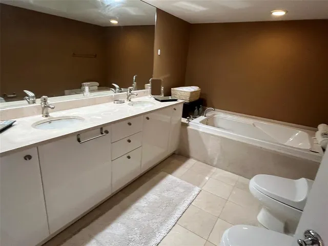 a bedroom with two beds and a flat screen tv