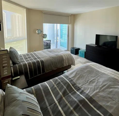 a bedroom with two beds and a couch