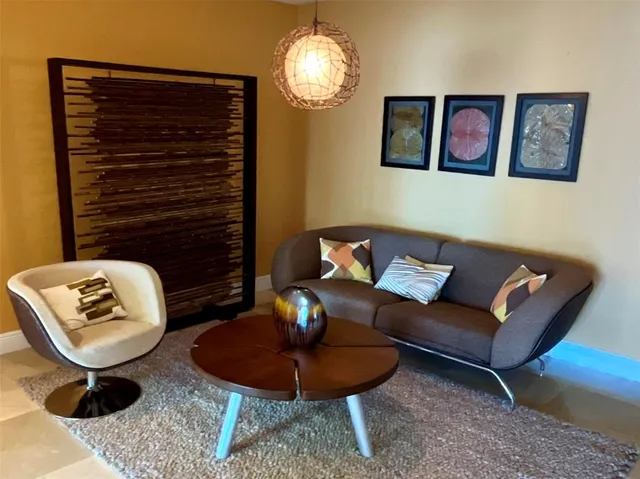 a living room with furniture and a lamp