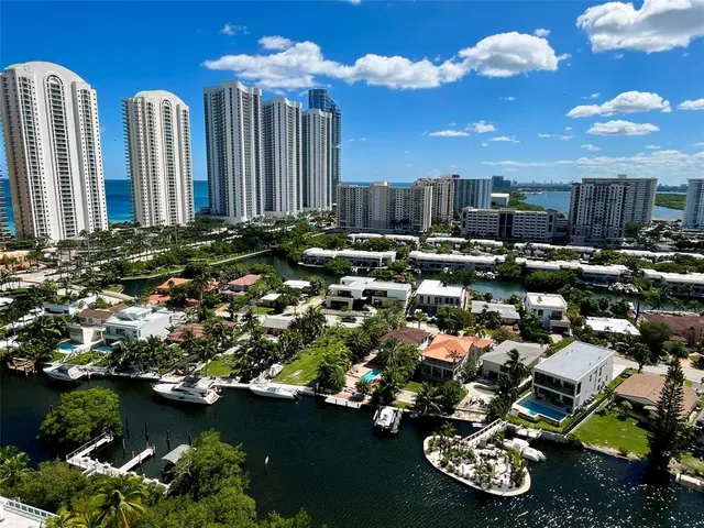 an aerial view of a house with a yard and lake view