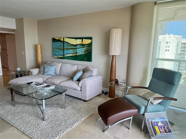a living room with furniture and a rug