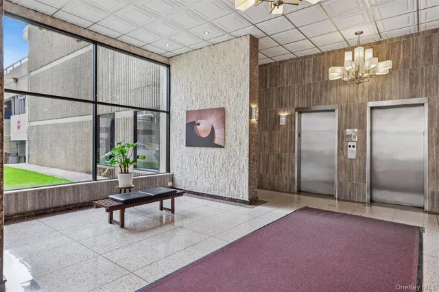 a living room with furniture a chandelier and a painting on the wall