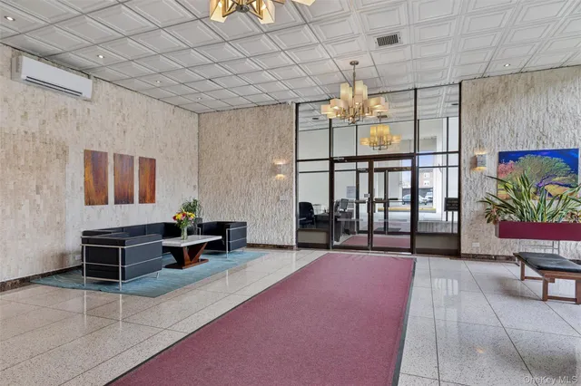 a spacious bedroom with a bed and a chandelier