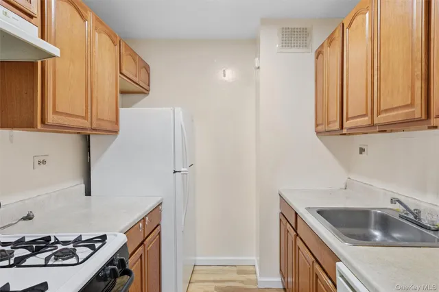 a kitchen with stainless steel appliances granite countertop a sink and a stove