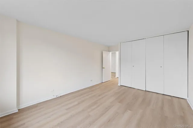 a view of an empty room and wooden floor