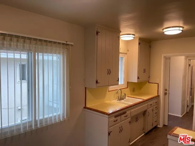 a spacious bathroom with a granite countertop tub sink and mirror