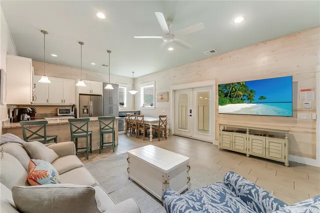 a living room with furniture kitchen view and a fireplace