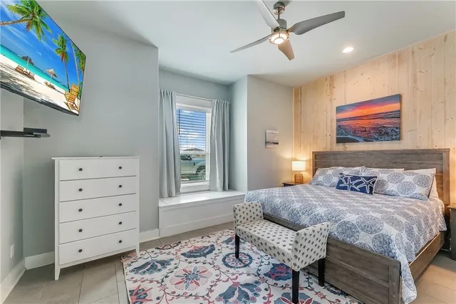 a bedroom with a bed dresser and a window